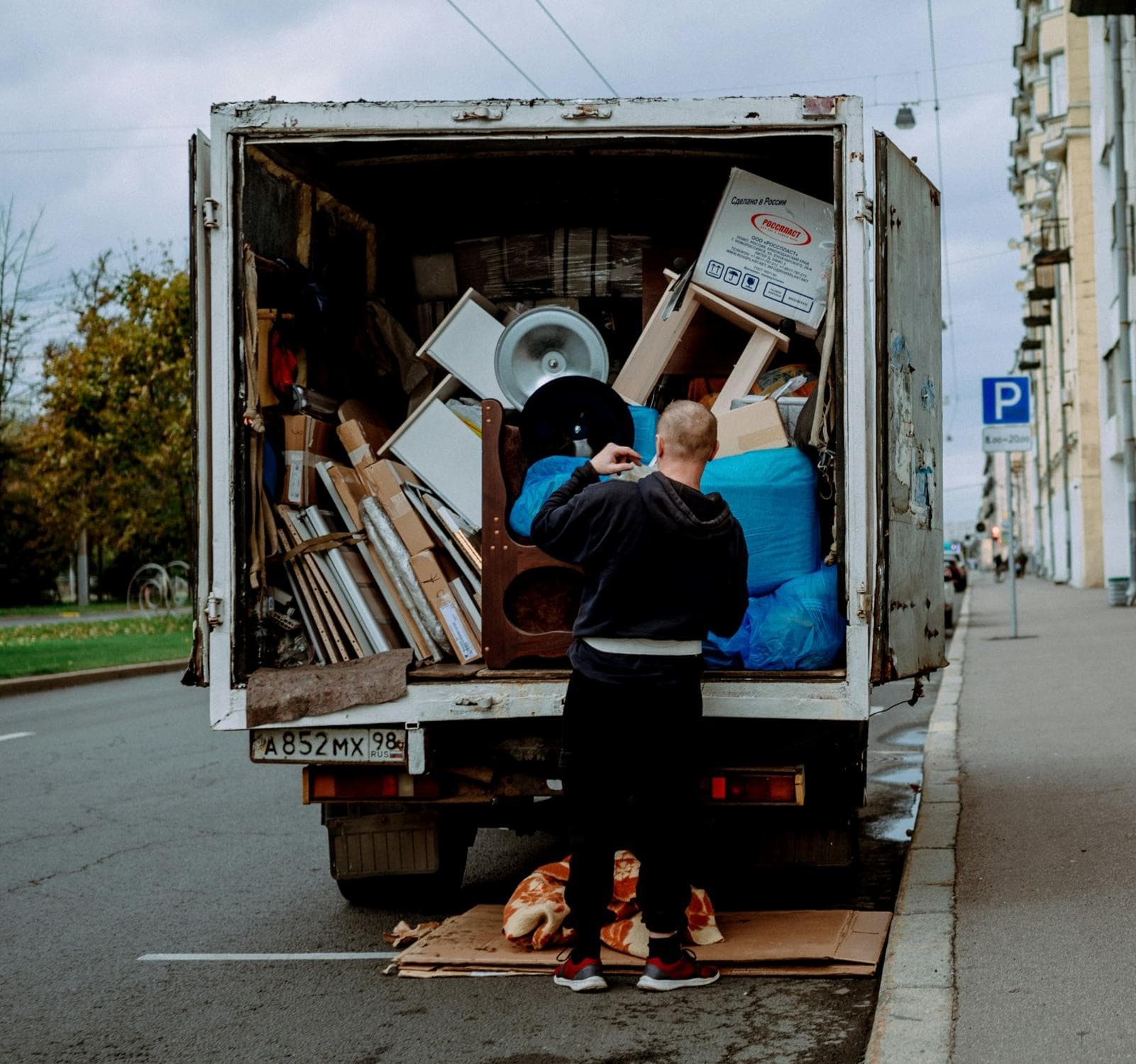 Clearance crew loading boxed and wrapped items into a van