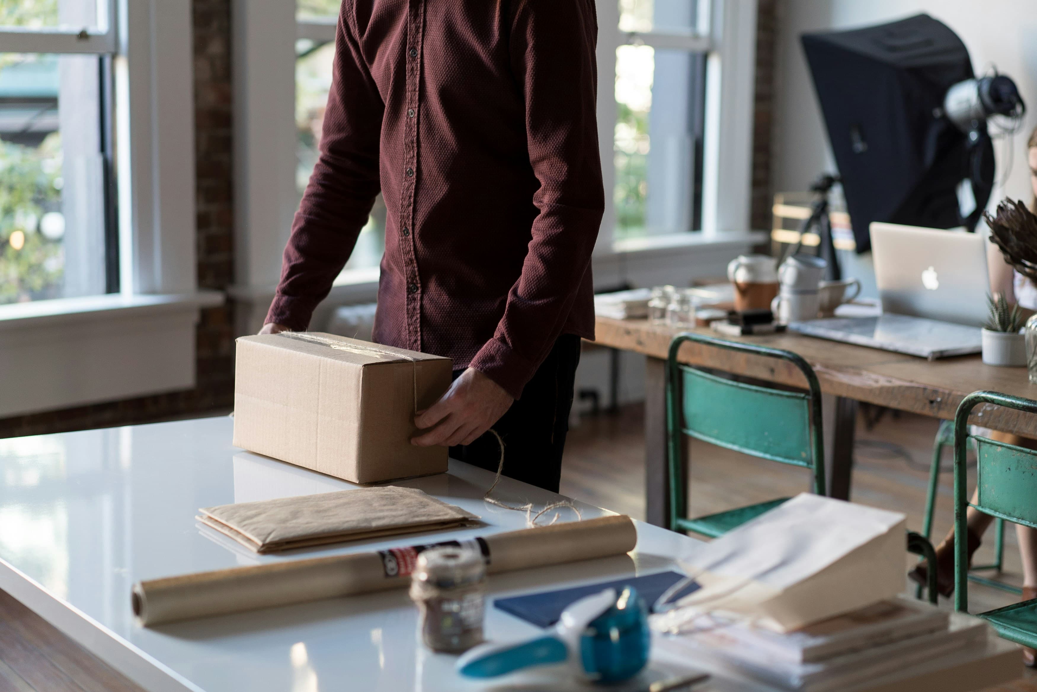 Office space being packed up with boxes on a desk